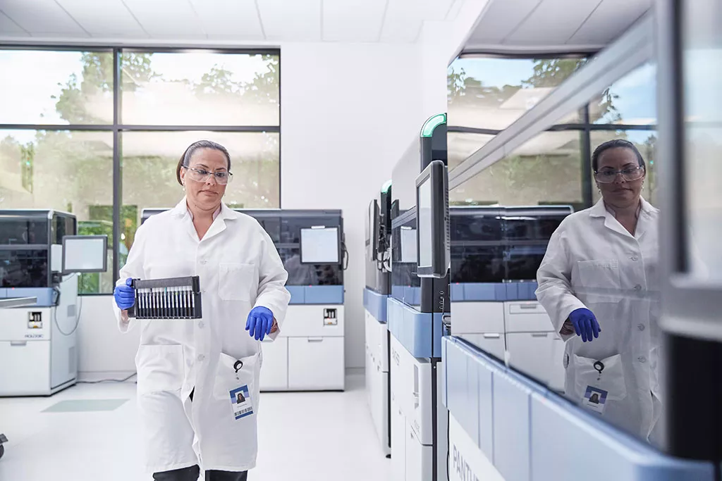Técnico de laboratorio con una bandeja de viales en un laboratorio
